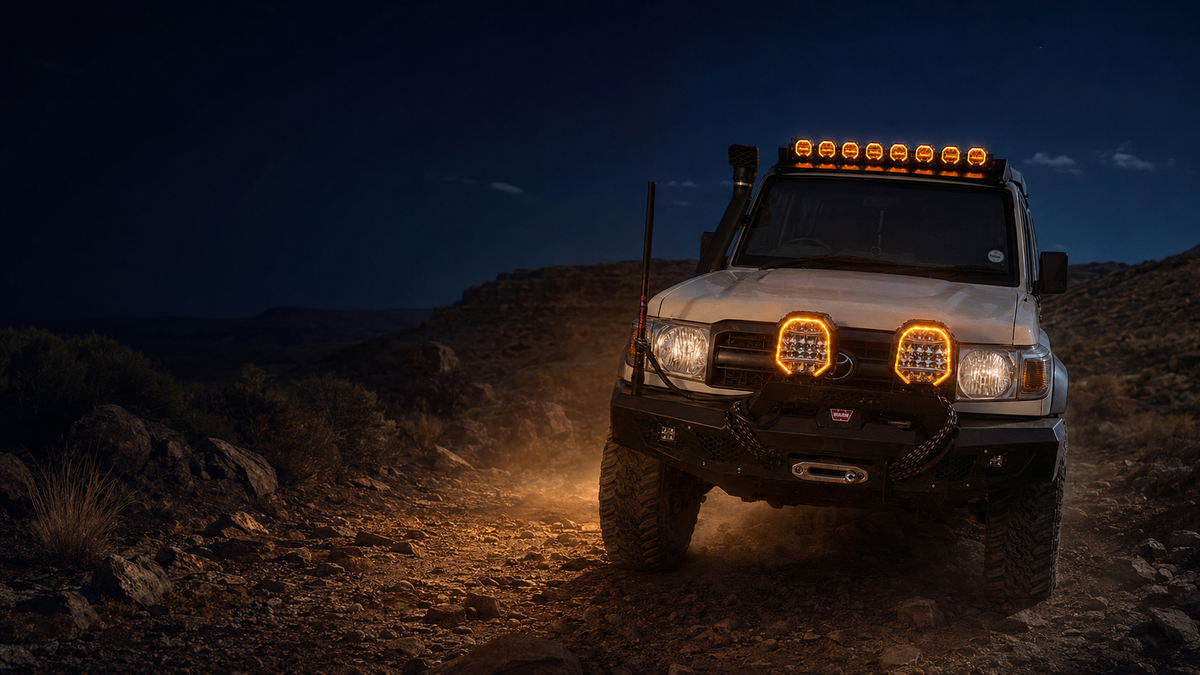 Four-wheel-drive vehicle using Aurora auxiliary lighting on a rocky trail after dark
